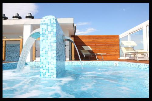 a swimming pool with a water slide in a house at Hotel Panama Majestic in Rimini