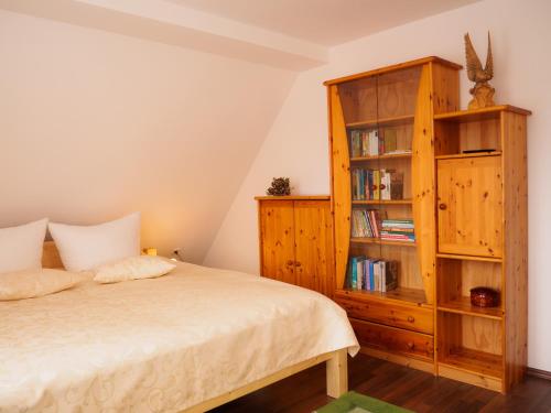 a bedroom with a bed and a book shelf at Haus am Fluss in Baiersbronn