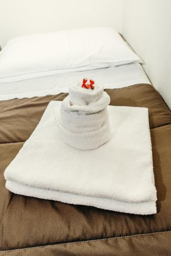 a pile of towels sitting on top of a bed at Casa Di Campagna In Toscana in Sovicille