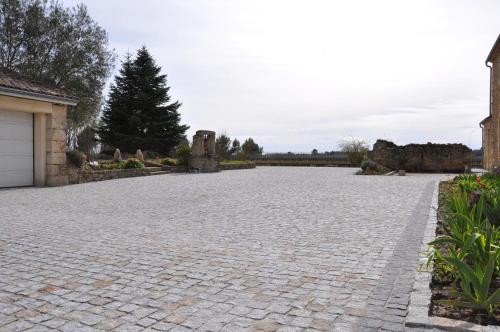 a stone driveway with a tree in the background at Chambre d'hôtes Sauternais in Pujols-sur-Ciron