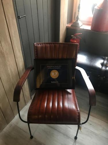 a brown chair with a laptop on top of it at Le Relais de Chassepierre in Chassepierre