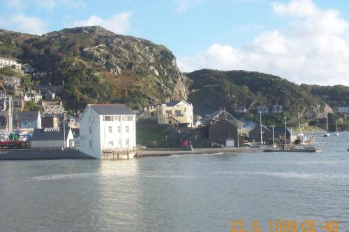 a body of water with houses and a mountain at Sunray Suites in Barmouth