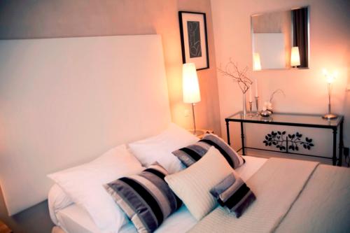 a bedroom with a bed with white and black pillows at DM hotel in Forbach