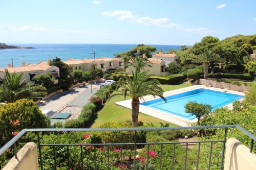 a view from the balcony of a villa with a swimming pool at Pasha Bay Residence in Sounio