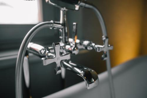 a close up of a bathroom faucet on a sink at MiaClara Relais in Alba