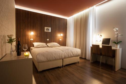 a hotel room with a bed and a desk at ECO Hotel Center in Postojna