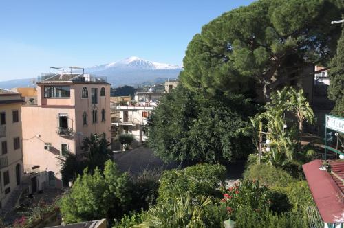 a view of a city with a mountain in the background at Villa Gaia in Taormina