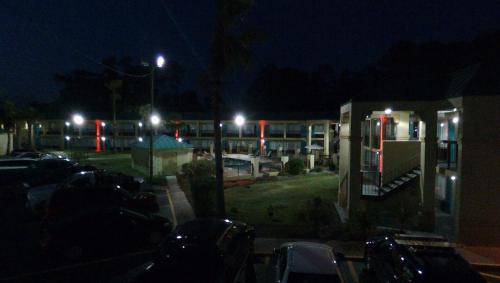 a parking lot with cars parked in front of a building at Econo Lodge in Hardeeville