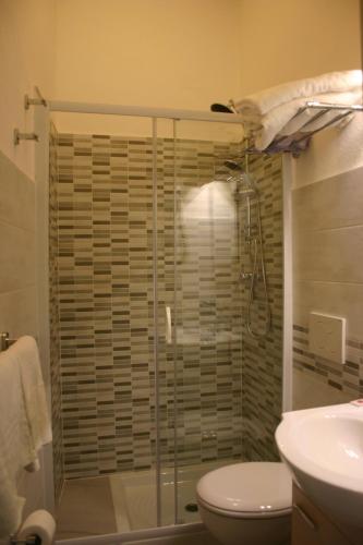 a bathroom with a shower with a toilet and a sink at Villa Gaia in Taormina