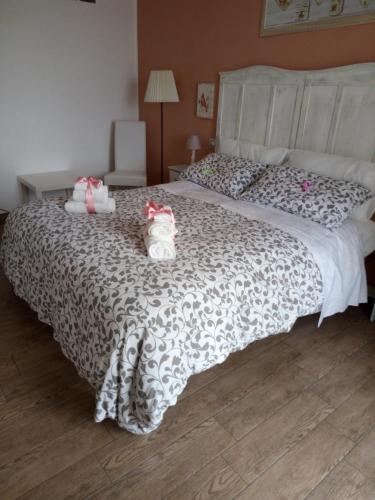 a bedroom with a large bed with two stuffed animals on it at Platea Oche in Sutri