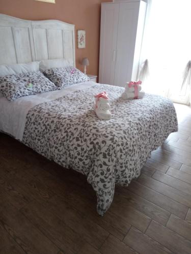 a bedroom with a bed with two stuffed animals on it at Platea Oche in Sutri