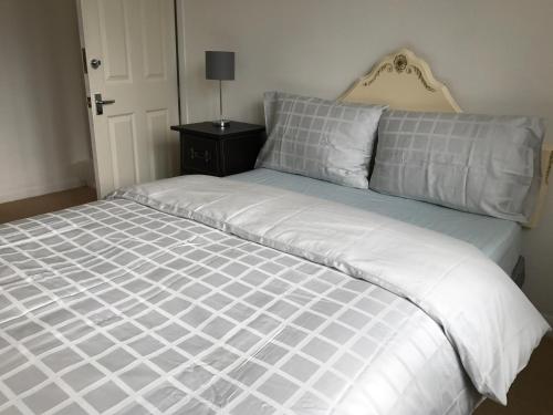 a large white bed in a bedroom at Wynchlands 4 Bedroom House in St Albans City in Saint Albans