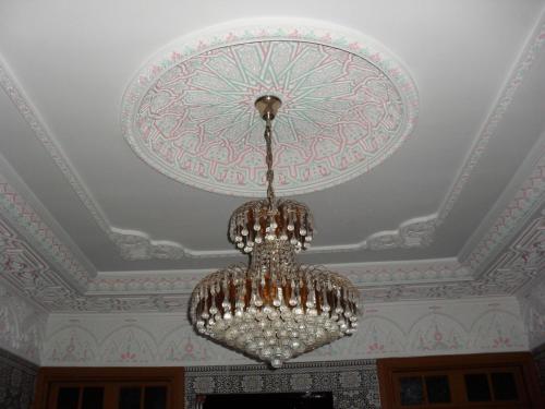 a chandelier hanging from a ceiling in a room at Médina Flat in Rabat