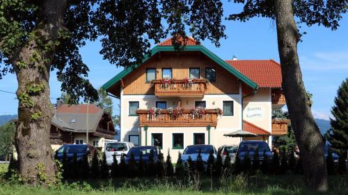 a building with cars parked in front of it at Pension Ballwein in Salzburg