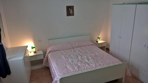 1 dormitorio con 1 cama y 2 mesitas de noche con lámparas en Vialunga, en Tuscania