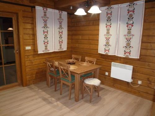 a dining room with a table and chairs at Drevenica u Maťa, Terchová in Terchová