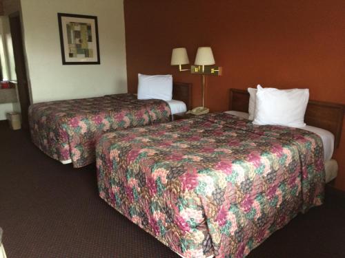 a hotel room with two beds and two lamps at Rexdale Inn in Seminole