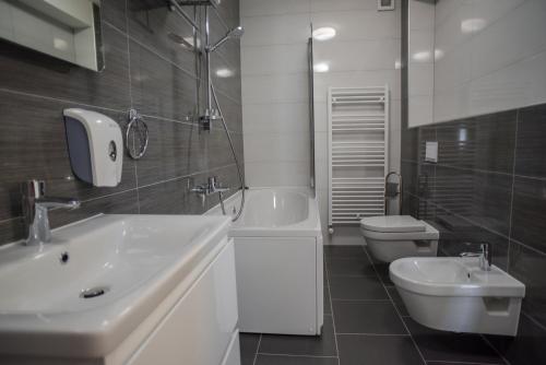 a white bathroom with a sink and a toilet at Villa Lika in Plitvička Jezera