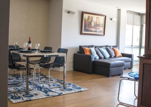 a living room with a table and a couch at Amazing Amial in Porto