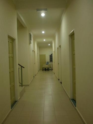 an empty hallway with a table in a building at Kerteh Inn in Kertih