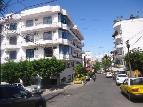 a city street with cars parked in front of a building at Olas Altas 534 Interior 4 in Puerto Vallarta