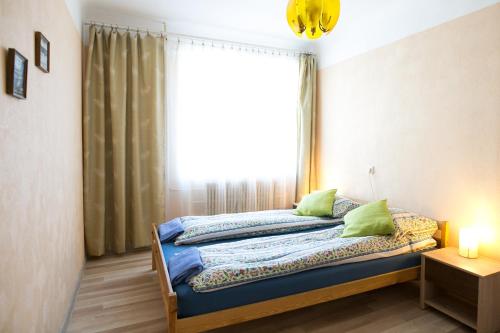 a bedroom with a bed in front of a window at Park Apartment in Ventspils