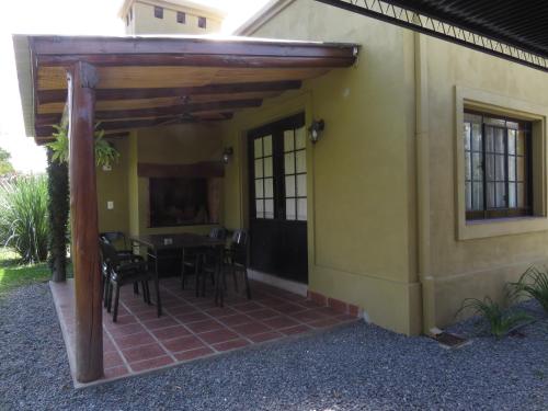 a patio of a house with a table and chairs at Posada del Santo Green & Rest - Cabañas in Salta