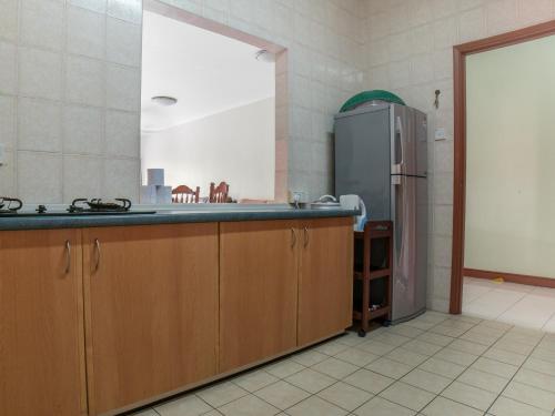 a kitchen with a stainless steel refrigerator in a room at Nana Marina Court in Kota Kinabalu