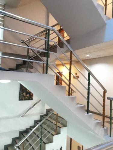 a white staircase with steel railings in a building at New Siam II in Bangkok