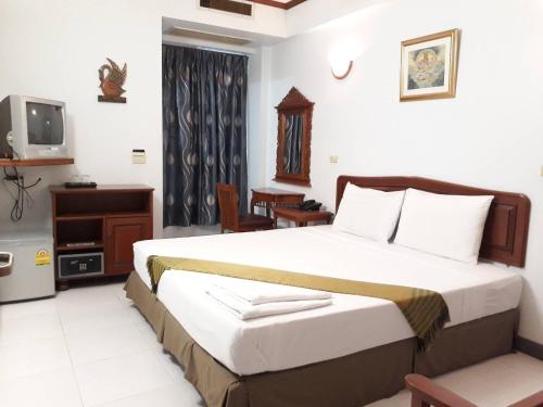 a bedroom with a large bed and a television at New Siam II in Bangkok