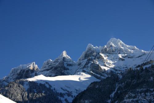 a view of a snow covered mountain with a ski lift at Boutique Hotel Beau-Séjour & Spa Superior in Champéry