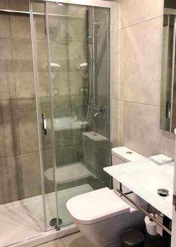 a bathroom with a shower and a toilet at Apartamentos Las Vegas in Ribadesella