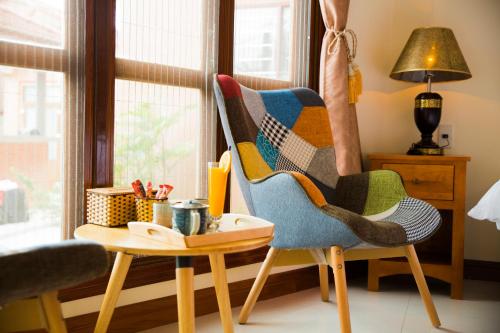 a living room with a chair and a table at Phong Nha Lake House Resort in Phong Nha