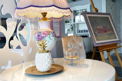 a lamp sitting on top of a table at New Belgrade Garni Hotel in Belgrade