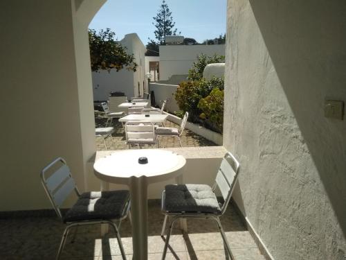 a group of tables and chairs on a balcony at Villa Petrusa in Stromboli