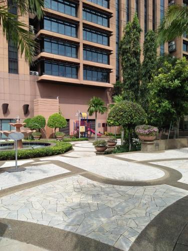 a walkway in front of a building with a building at Grand Service Apartment @ Times Square in Kuala Lumpur