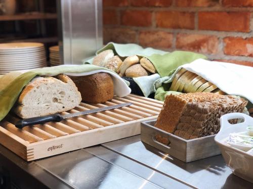 a bunch of different types of bread on a table at Hotell Nordic in Norrköping