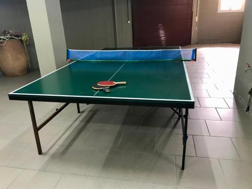 a ping pong table with a ping paddle on it at Vrontados Villa in Vrontados