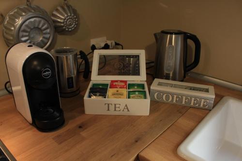 a counter top with a coffee maker and a tea at L'Alba sui Templi in Agrigento