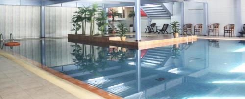 a pool of water with plants in a building at Sumai Hotel Apartment in Kuala Terengganu