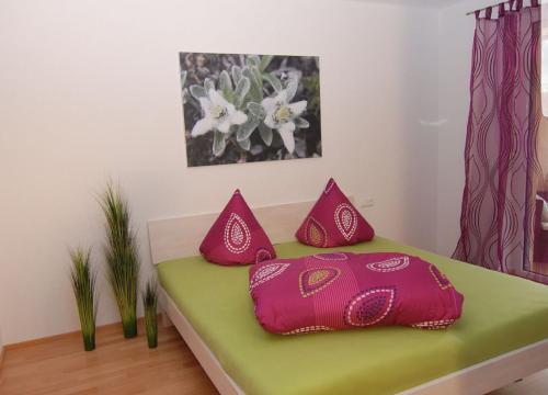 a room with a bed with red pillows on it at Appartement Annabelle Top 13 in Damuls