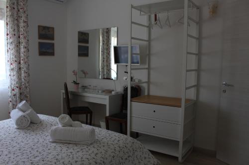 a bedroom with a bed and a desk and a bed and a mirror at L'Alba sui Templi in Agrigento