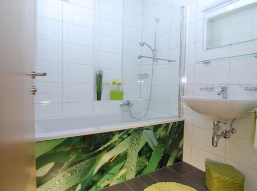 a bathroom with a fish tank on the wall at Appartement Annabelle Top 13 in Damuls