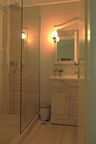 a bathroom with a shower and a sink and a mirror at Villa Alba Chiara in Ouranoupoli