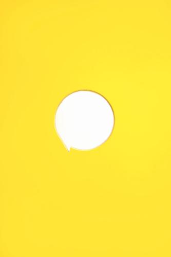 a white speech bubble on a yellow background at Konko Hostel Jakarta in Jakarta