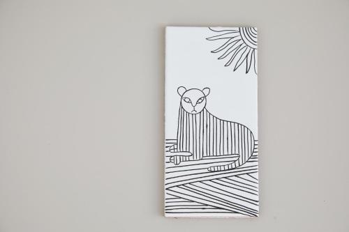 a drawing of a cat sitting on a table at Ya Do! KYOTO OKAZAKI in Kyoto