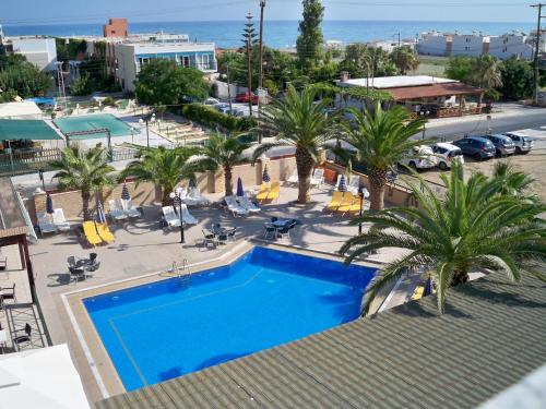 an overhead view of a swimming pool with palm trees at Palladion in Adelianos Kampos