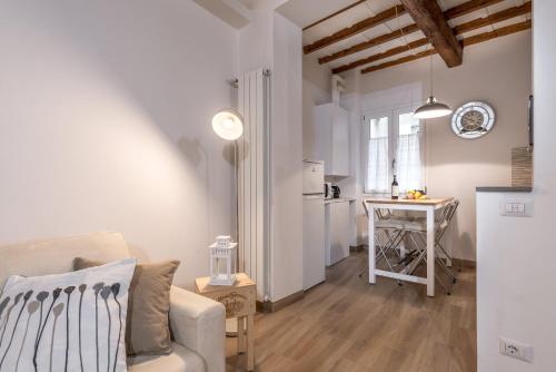 a white living room with a couch and a table at Santa Croce Place by Mmega in Florence