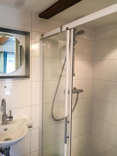 a bathroom with a shower and a sink at Apple Tree Cottage - charming home at beautiful canal in our idyllic garden in Gouda