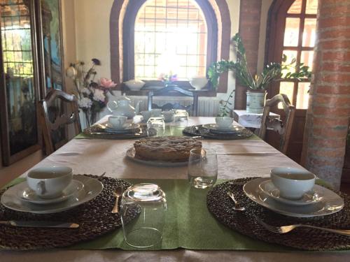 a dining room table with a cake on top of it at B&B civico 7 in Vignola